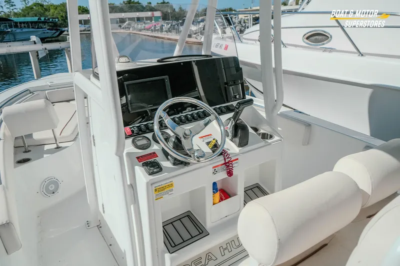 Slide: The Image of 2021 Sea Hunt Ultra 229 boat dashboard with steering wheel and controls. - 26