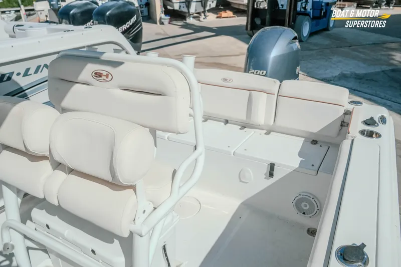Slide: The Image of 2021 Sea Hunt Ultra 229 boat interior with white seating and Yamaha outboard motor. - 29