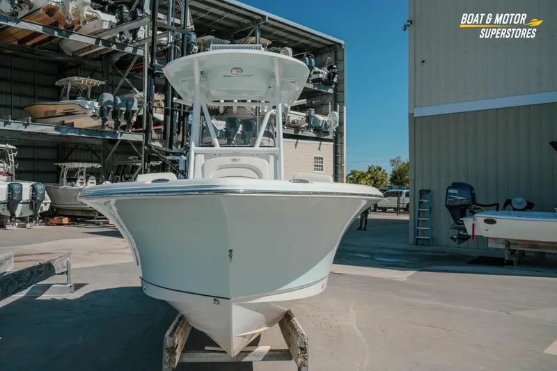 Slide: The Image of 2021 Sea Hunt Ultra 229 boat displayed at a marina with stacked vessels. - 36