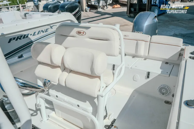 Slide: The Image of 2021 Sea Hunt Ultra 229 boat interior with white seating and steering console. - 5