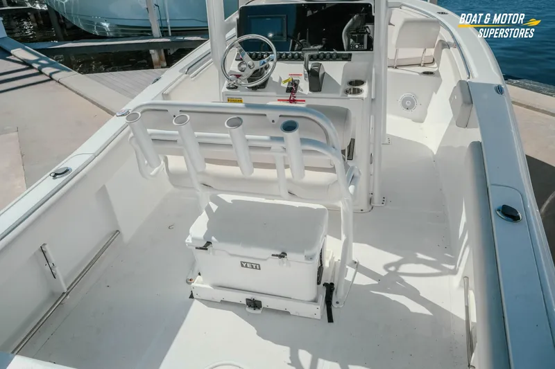 Slide: The Image of 2021 Sea Hunt Ultra 229 boat interior with steering console and Yeti cooler. - 8