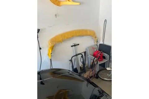 Slide: The Image of 2008 Chaparral Sunesta 224 boat equipment stored in a garage with various items. - 16