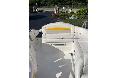 Slide: The Image of 2008 Chaparral Sunesta 224 boat interior with white seating and yellow accents. - 4