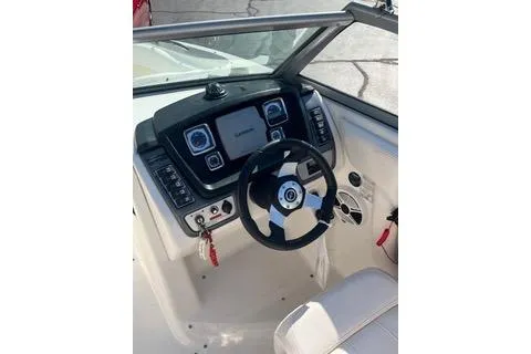 Slide: The Image of 2008 Chaparral Sunesta 224 boat dashboard with steering wheel and control panel. - 8
