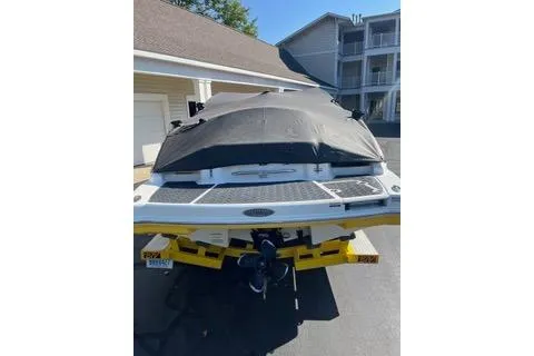 Slide: The Image of 2008 Chaparral Sunesta 224 boat with cover, parked on a trailer in a driveway. - 9