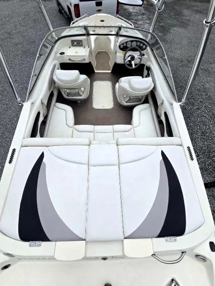 Slide: The Image of 2008 Stingray 205 LS/LX/LR boat interior with white seating and dashboard view. - 4