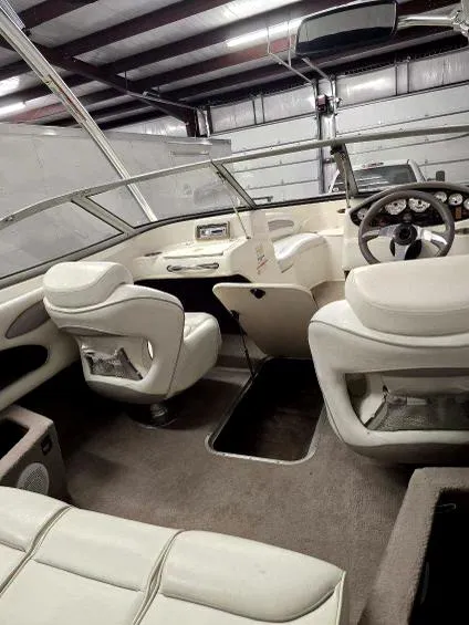 Slide: The Image of 2008 Stingray 205 LS/LX/LR boat interior with white seating and steering wheel. - 8