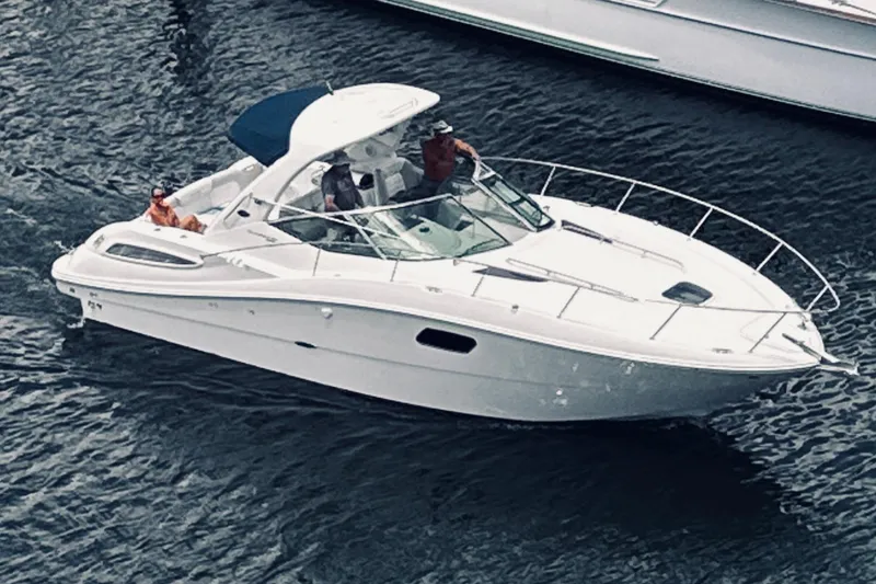 The Image of 2012 Sea Ray Sundancer 350 cruising on water with passengers onboard. - 1