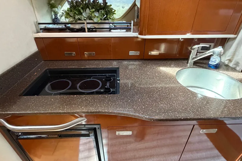 Slide: The Image of Luxurious 2012 Sea Ray Sundancer 350 yacht kitchen with modern appliances and elegant wood cabinetry. - 11