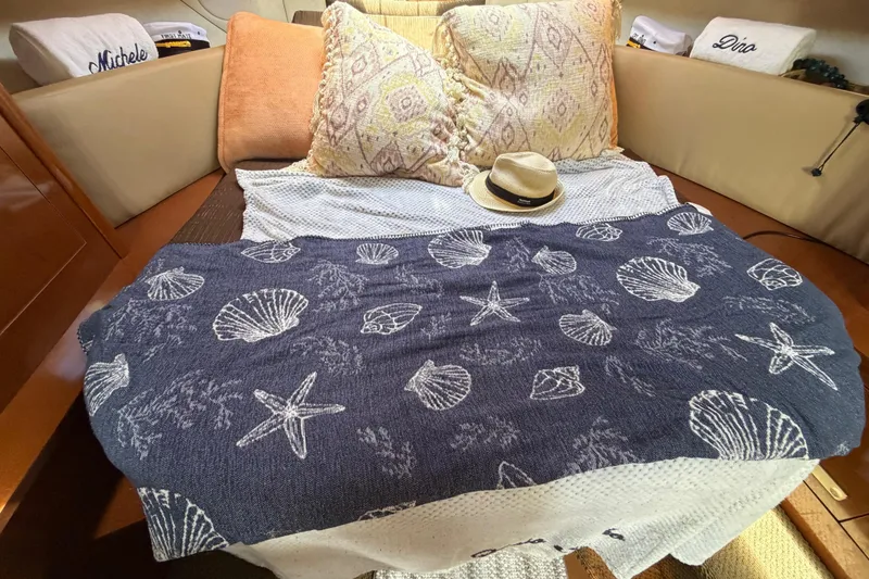 Slide: The Image of Cozy cabin interior of 2012 Sea Ray Sundancer 350 with nautical-themed bedding and pillows. - 12