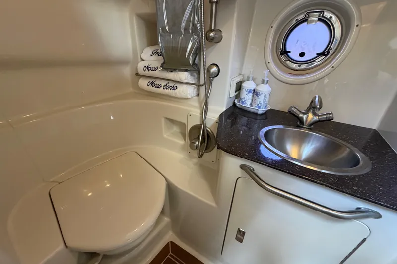 Slide: The Image of Luxurious bathroom in 2012 Sea Ray Sundancer 350 yacht with sink, toilet, and porthole window. - 16