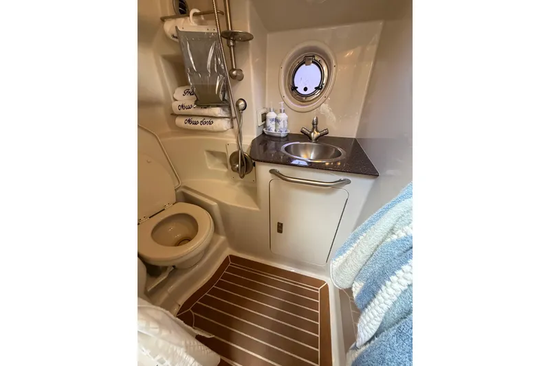 Slide: The Image of Luxurious bathroom in 2012 Sea Ray Sundancer 350 yacht with sink, toilet, and porthole. - 17
