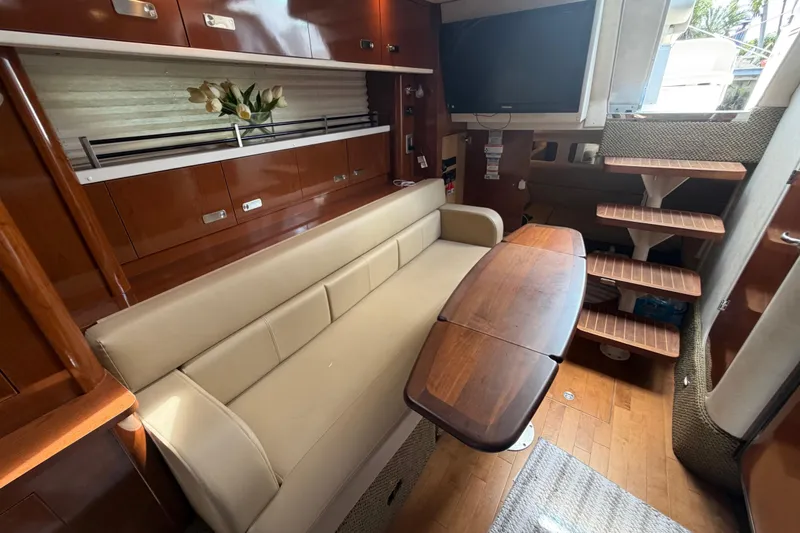 Slide: The Image of Luxurious interior of 2012 Sea Ray Sundancer 350 yacht with sofa and wooden table. - 20
