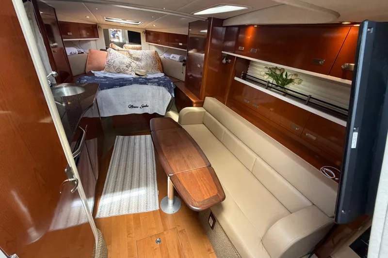 Slide: The Image of Luxurious interior of 2012 Sea Ray Sundancer 350 yacht with cozy seating and elegant wood finishes. - 22