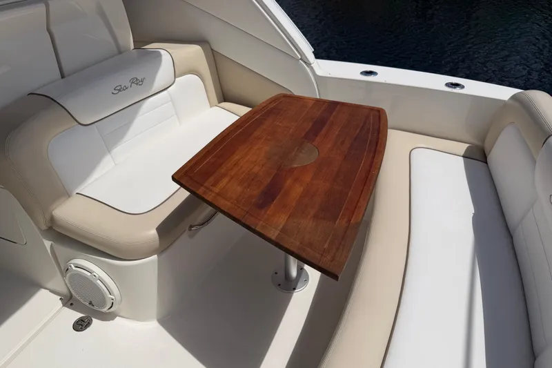 Slide: The Image of Luxurious seating area on a 2012 Sea Ray Sundancer 350 with a wooden table. - 27