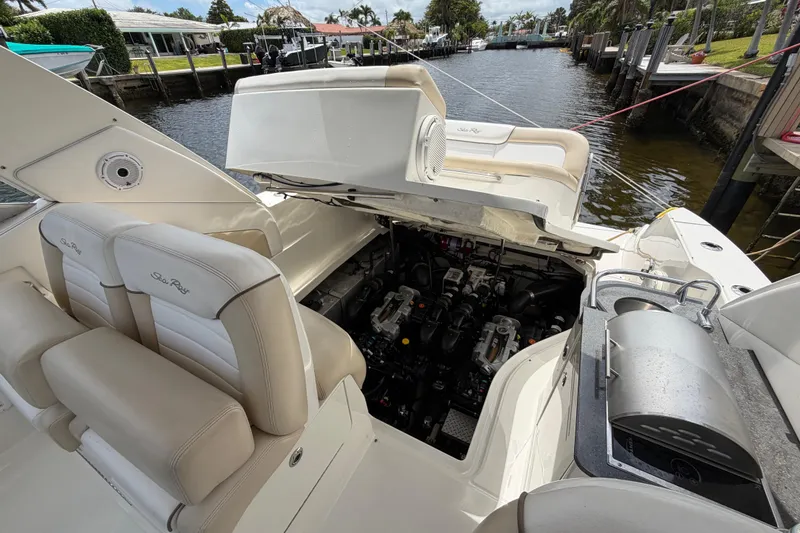 Slide: The Image of 2012 Sea Ray Sundancer 350 boat with open engine compartment, docked by a canal. - 33