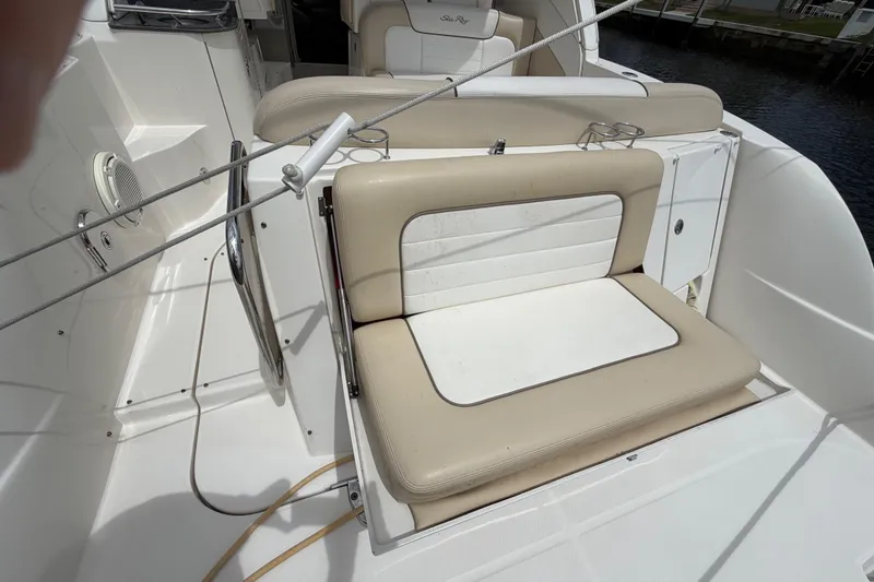 Slide: The Image of 2012 Sea Ray Sundancer 350 boat seating area with beige cushions and cup holders. - 39