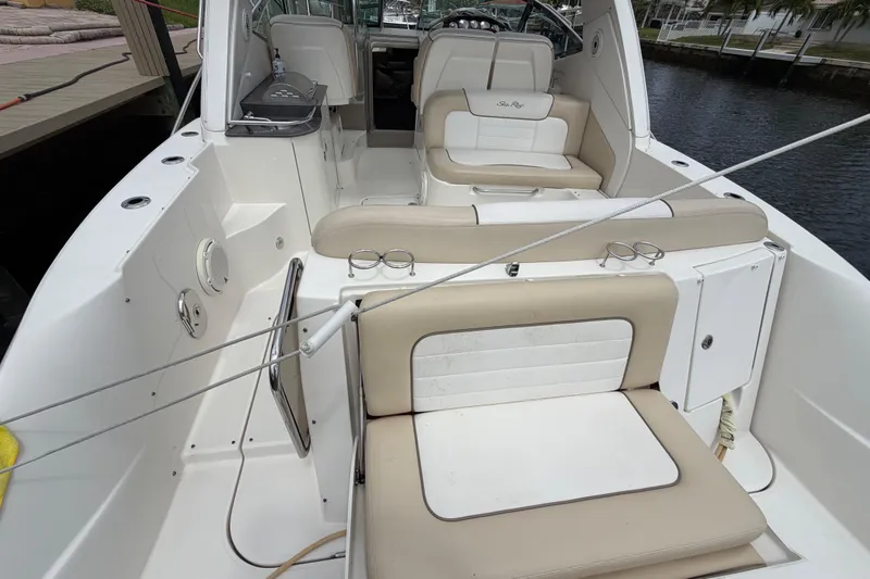 Slide: The Image of 2012 Sea Ray Sundancer 350 boat interior with beige seating and cup holders. - 40