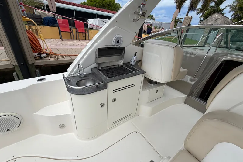 Slide: The Image of 2012 Sea Ray Sundancer 350 boat interior with kitchenette and seating area. - 41