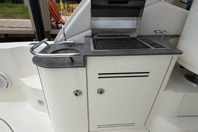Slide: The Image of Outdoor kitchen on a 2012 Sea Ray Sundancer 350 yacht with grill and sink. - 42