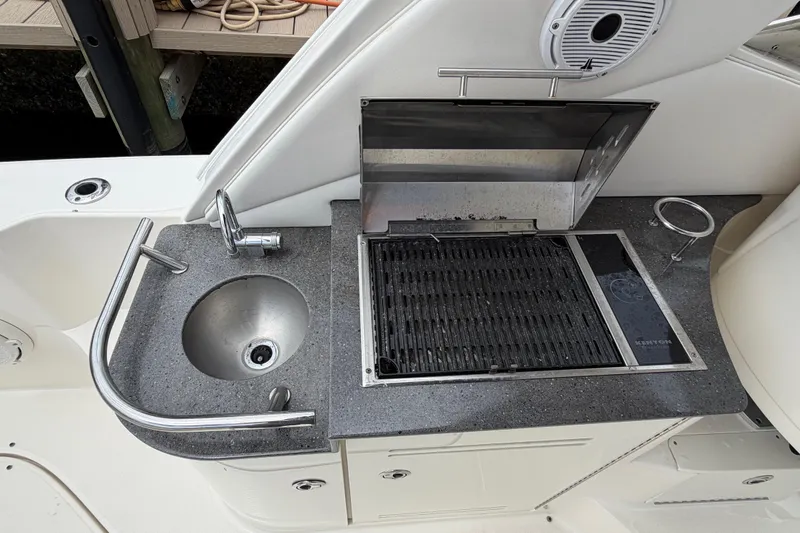Slide: The Image of Outdoor kitchenette on 2012 Sea Ray Sundancer 350 with sink and grill. - 43