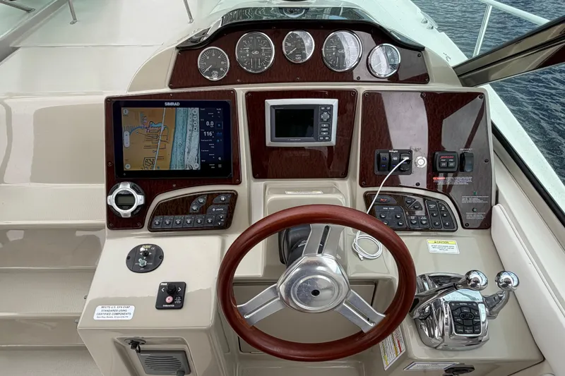 Slide: The Image of Cockpit of 2012 Sea Ray Sundancer 350 with navigation system and wooden steering wheel. - 47