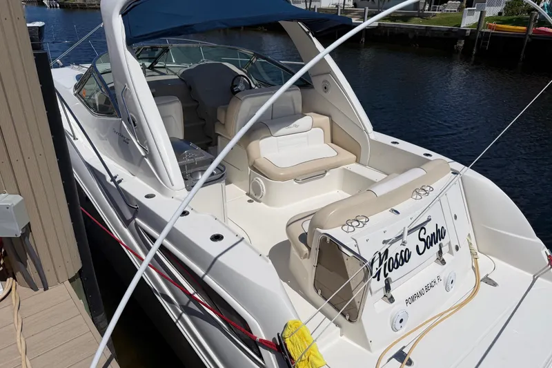 Slide: The Image of 2012 Sea Ray Sundancer 350 docked, featuring spacious seating and sleek design. - 5