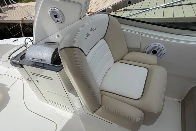 Slide: The Image of 2012 Sea Ray Sundancer 350 boat seat with built-in grill and speaker. - 56