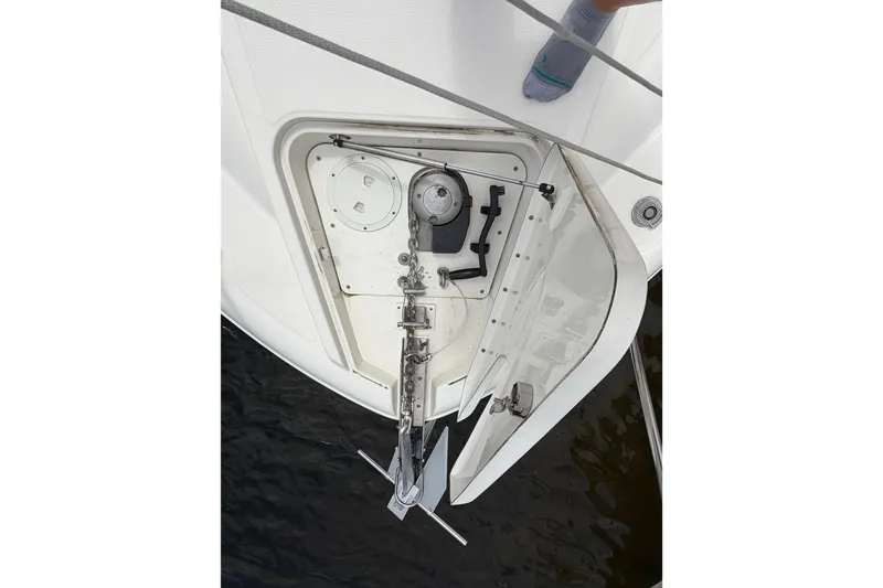 Slide: The Image of Anchor compartment of 2012 Sea Ray Sundancer 350 boat, showing anchor and chain mechanism. - 58