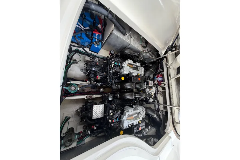 Slide: The Image of Engine compartment of a 2012 Sea Ray Sundancer 350, showcasing dual engines and mechanical components. - 59