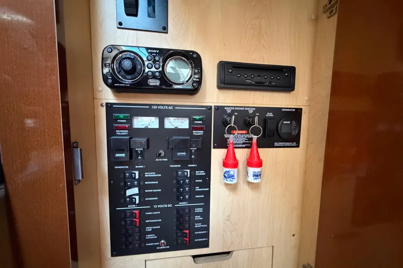 Slide: The Image of Control panel of a 2012 Sea Ray Sundancer 350 boat with switches and stereo system. - 8