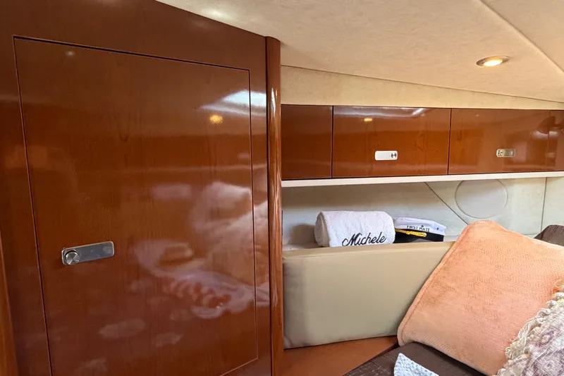 Slide: The Image of Interior of 2012 Sea Ray Sundancer 350 with wooden cabinets and cozy seating area. - 9