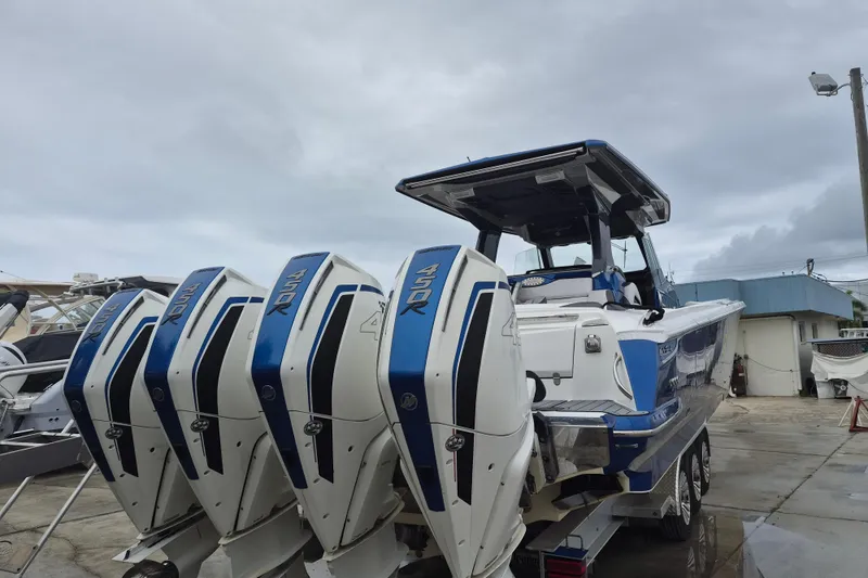 Slide: The Image of 2020 Nor-Tech 450 Sport Center Console helm with dual navigation screens and steering wheel. - 27