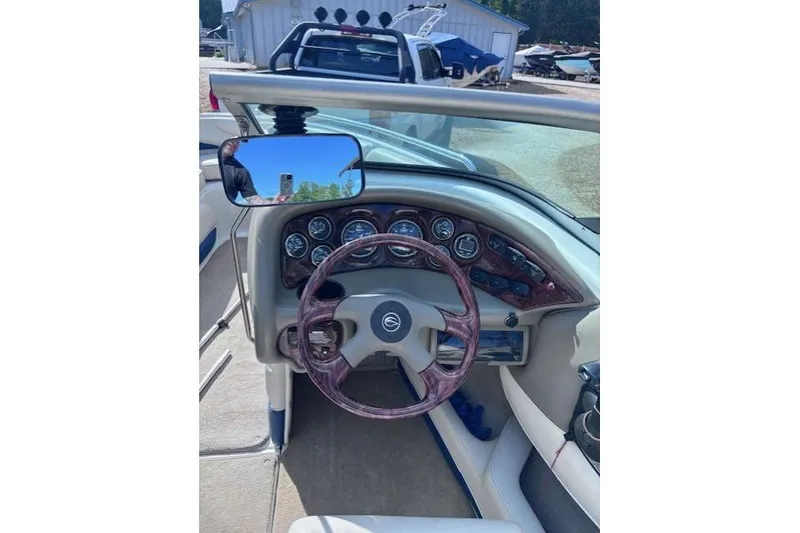 Slide: The Image of 2005 Crownline 202 BR boat dashboard with steering wheel and gauges. - 6