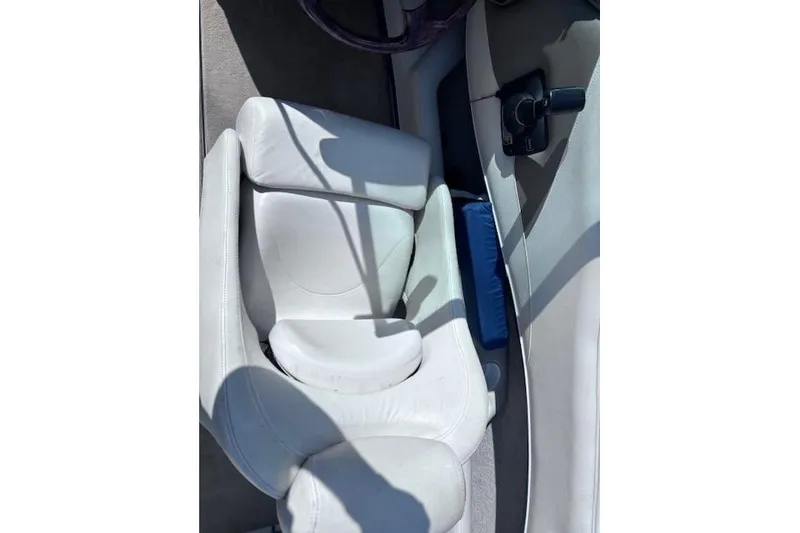 Slide: The Image of White leather seat in a 2005 Crownline 202 BR boat interior. - 7