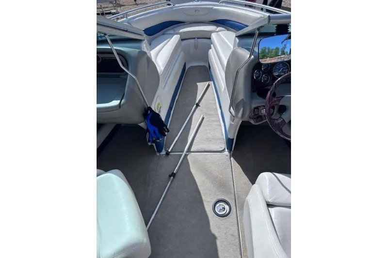 Slide: The Image of Interior of a 2005 Crownline 202 BR boat with white seating and steering wheel. - 8