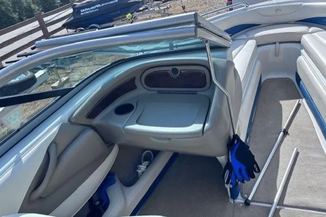 Slide: The Image of 2005 Crownline 202 BR boat interior with seating, storage, and blue accents. - 9