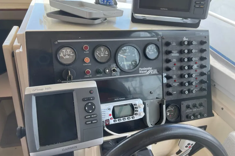 Slide: The Image of Control panel of a 1998 Albin 28 Tournament Express with Garmin GPS and various gauges. - 11