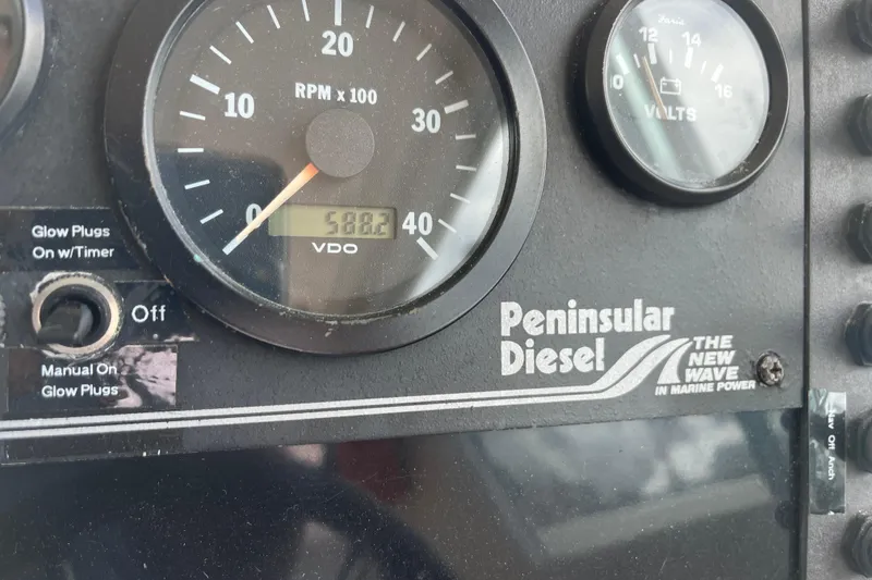 Slide: The Image of Instrument panel of a 1998 Albin 28 Tournament Express with Peninsula Diesel branding. - 13