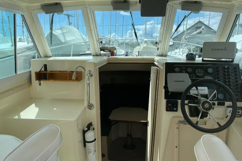 Slide: The Image of 1998 Albin 28 Tournament Express cockpit with Garmin navigation, steering wheel, and cabin entrance. - 17