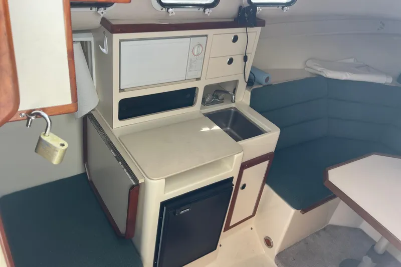 Slide: The Image of Interior of 1998 Albin 28 Tournament Express with kitchenette and seating area. - 18
