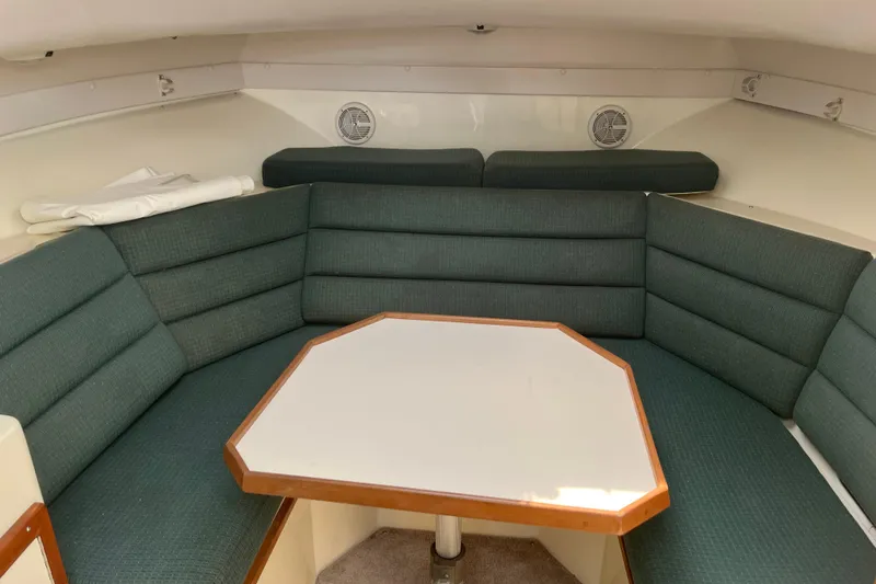 Slide: The Image of Interior of 1998 Albin 28 Tournament Express with cushioned seating and table. - 20