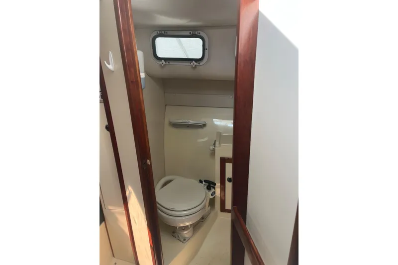 Slide: The Image of 1998 Albin 28 Tournament Express boat bathroom with toilet and window. - 22