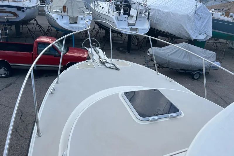 Slide: The Image of 1998 Albin 28 Tournament Express boat on dry dock with red truck nearby. - 25