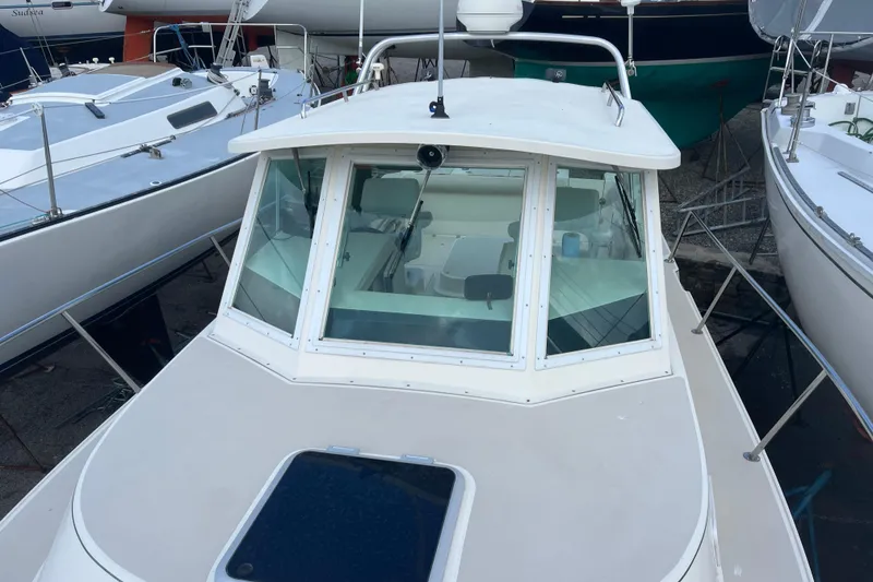 Slide: The Image of 1998 Albin 28 Tournament Express boat docked among other vessels. - 28