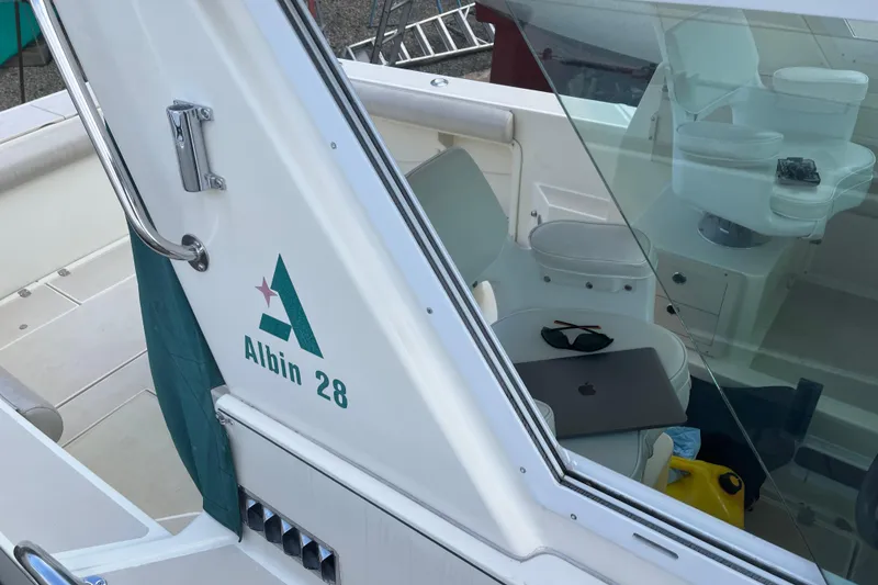 Slide: The Image of 1998 Albin 28 Tournament Express boat interior with logo and seating area. - 33