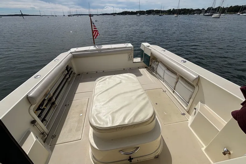 Slide: The Image of 1998 Albin 28 Tournament Express boat deck with seating, overlooking a serene water view. - 5