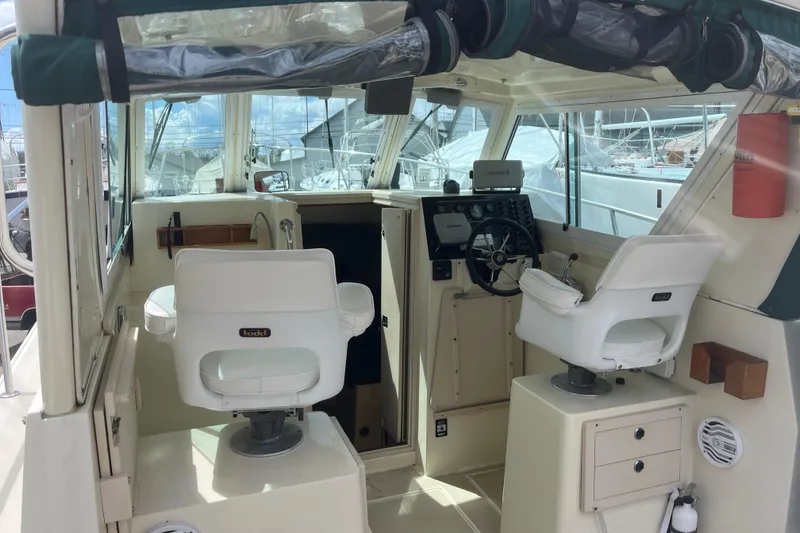 Slide: The Image of Interior view of a 1998 Albin 28 Tournament Express boat cockpit with steering wheel and seats. - 6