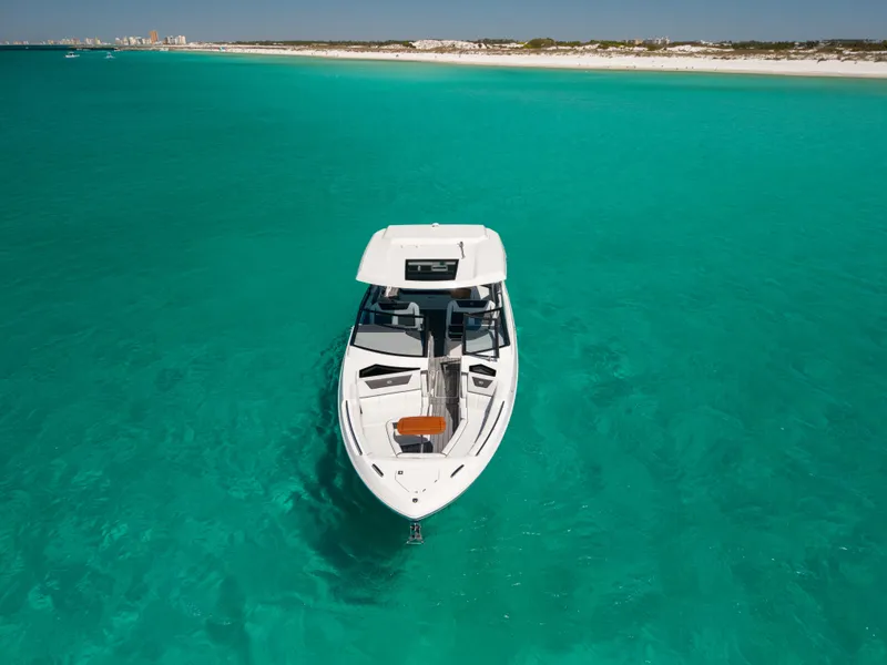 Slide: The Image of 2024 Cobalt R35 boat on turquoise water near coastline. - 10