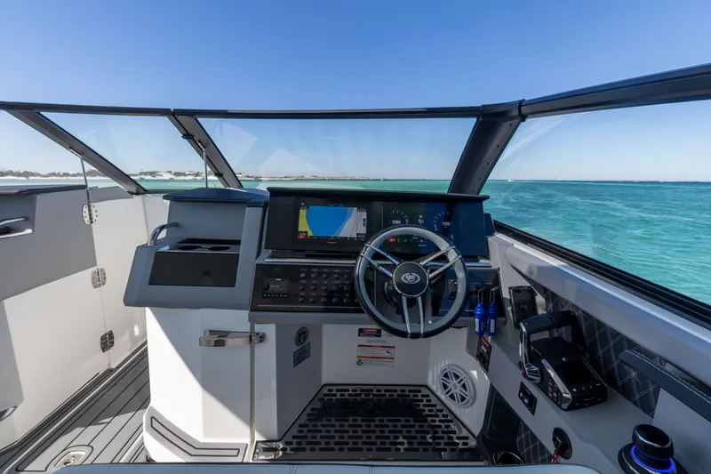 Slide: The Image of Interior view of 2024 Cobalt R35 boat cockpit on open water. - 22